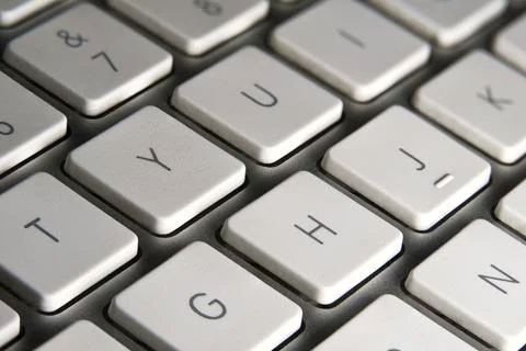 Computer keyboard with white keys and silver metallic structure. Some letters Foto stock