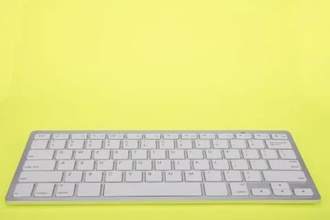 Computer keyboard on yellow background Stock Photos