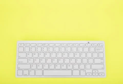 Computer keyboard on yellow background Stock Photos