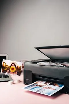 Computer laptop and printer on table. Printing photos Stock Photos
