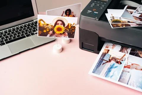 Computer laptop and printer on table. Printing photos 스톡 사진