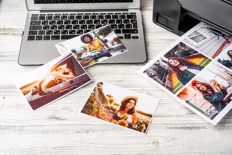 Computer laptop and printer on table. Printing photos 스톡 사진