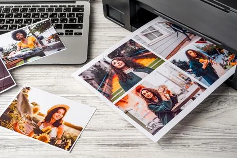 Computer laptop and printer on table. Printing photos Stock Photos