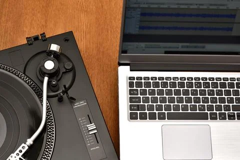 Computer laptop and turntable for digitizing vinyl records. Stock Photos