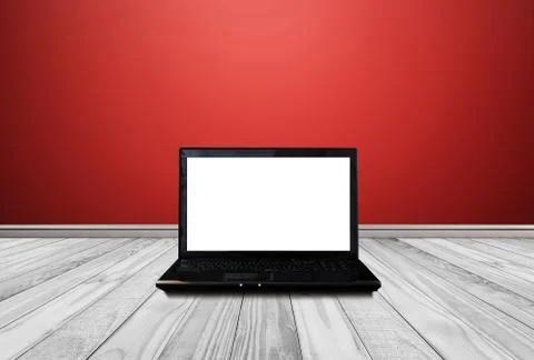 Computer laptop with blank empty white screen, on white wood floor with red wall Stock Photos