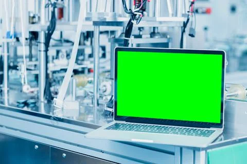 Computer laptop blank green screen on science lab advance machine automation  Stock Photos