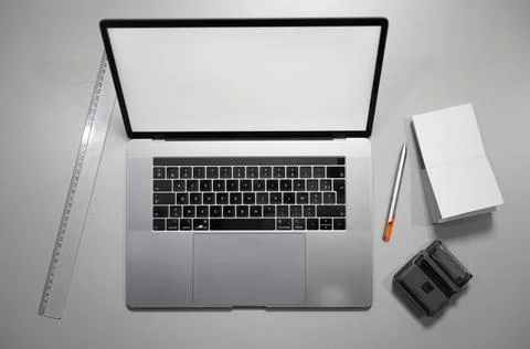 Computer laptop with blank screen on a silver office desk, top view 库存照片