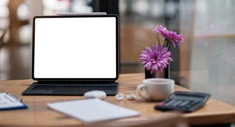 Computer Laptop with blank screen on table of coffee shop blur background with Stock Photos