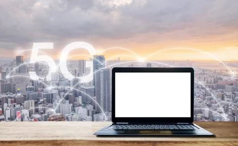 Computer laptop with blank white screen, and city view with 5G internet Stock Photos