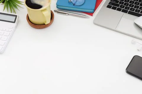 Computer laptop, calculator, coffee cup and smart phone on white table, Top v Foto stock