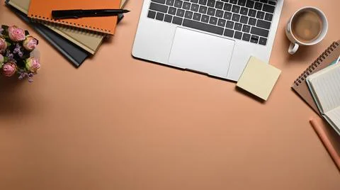 Computer laptop, coffee cup, notebook and sticky notes on beige background. Stock Photos