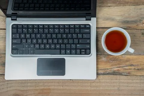 Computer laptop with cup of tea Stock Photos