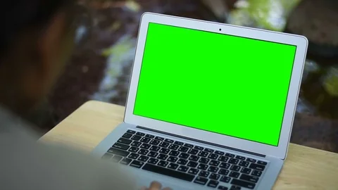 Computer laptop with green screen display near the creek. Stock Footage 97856855