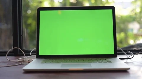 Computer laptop with green screen on the table of cafe. Stock Footage 85043559
