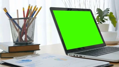 Computer laptop green screen on workplace table. Stockbeeldmateriaal 81262575