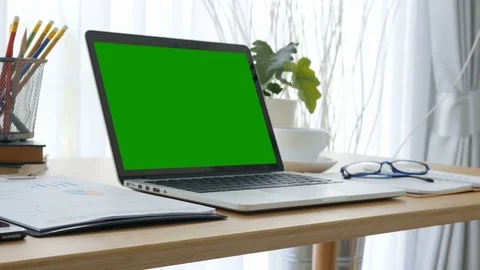 Computer laptop green screen on workplace table. 스톡 동영상 81264433