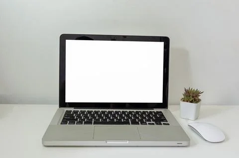 Computer laptop mock up and mouse Cactus white blank screen on table. Used .. Stock Photos