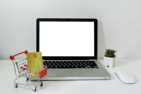 Computer laptop mock up blank white and cart and credit card on desk. Used .. Stock Photos