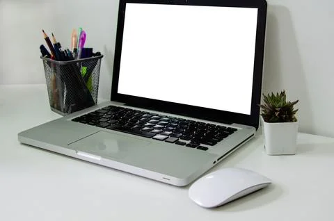 Computer laptop mock up blank white and mouse on desk. Used to put text or .. Stock Photos