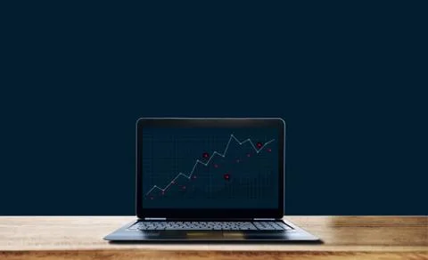 Computer laptop with raising graph on screen, on blue background Stock Photos