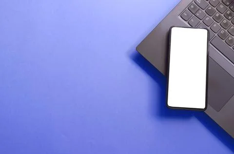 Computer, laptop, smartphone isolated screen on blue background workspace Stock Photos