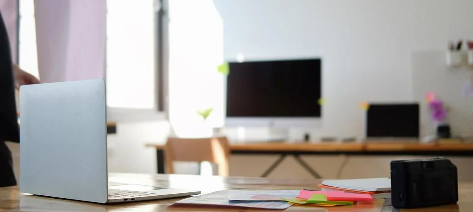 Computer laptop, sticky notes and colour swatches on white table at creative  Stock Photos