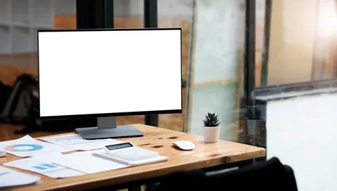 Computer laptop with white blank screen putting on wooden working desk that Stock Photos