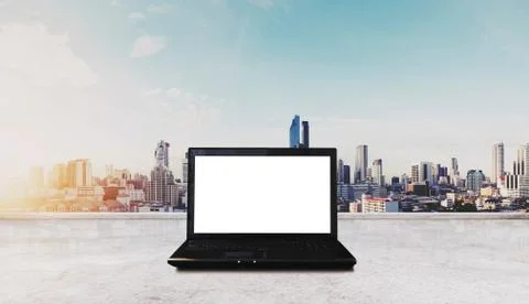 Computer laptop on white table, with Bangkok city view in sunrise background Stock Photos