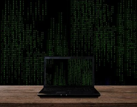 Computer Laptop on wood table, with abstract computer code graphic background 写真素材