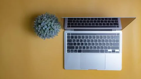 Computer laptop on yellow background. Copy space Stock Photos