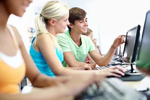 Computer, learning and discussion with students in classroom for education,.. Stock Photos