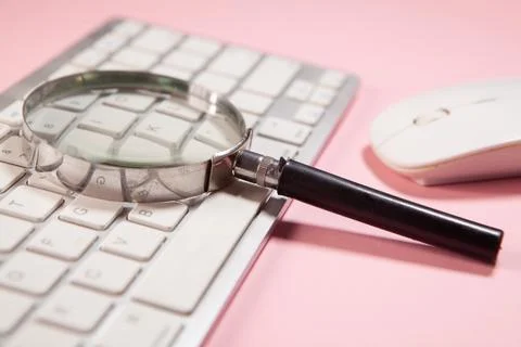 Computer with a magnifying glass Stock Photos