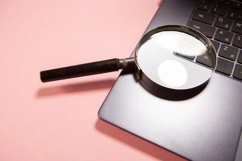 Computer with a magnifying glass Stock Photos
