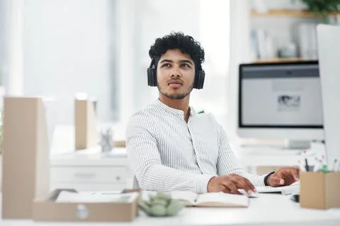 Computer, man and thinking with headphones in office for audio transcriptio.. Stock Photos