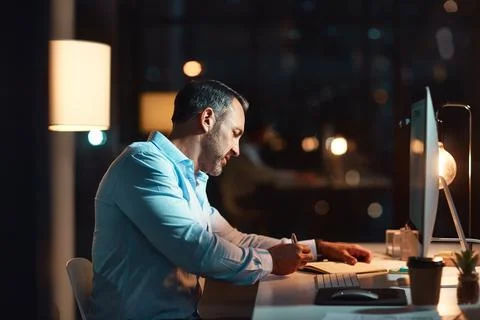 Computer, man and writing notes in office at night for trade details, price.. Stock Photos