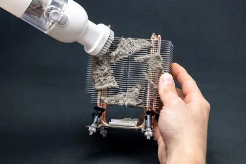 Computer master cleans the radiator of the computer cooling system, computer  Stock Photos