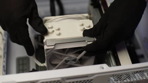 Computer master in gloves installing new fan in system unit of desktop computer Stock Footage 270606107