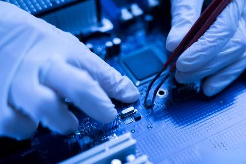 Computer master in gloves working with tweezers on   cpu board Stock Photos