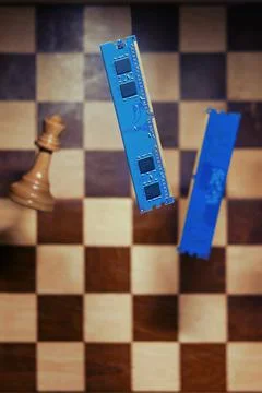 Computer memory and an old chessboard with chess pieces. Concept of technolog 写真素材