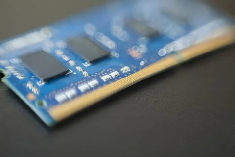 Computer memory chip placed on top of a black table. Connections and circuits Stock Photos