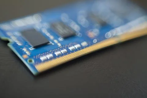 Computer memory chip placed on top of a black table. Connections and circuits Stock Photos