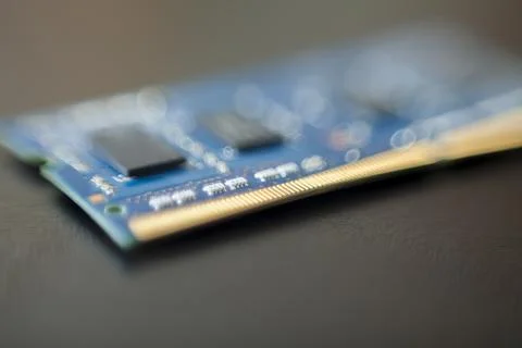Computer memory chip placed on top of a black table. Connections and circuits Stock Photos