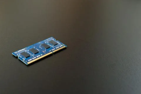 Computer memory chip placed on top of a black table. Connections and circuits Stock Photos