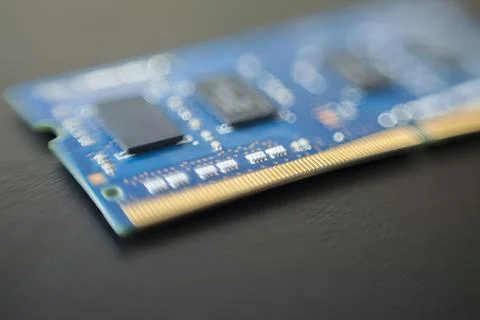 Computer memory chip placed on top of a black table. Connections and circuits Stock Photos