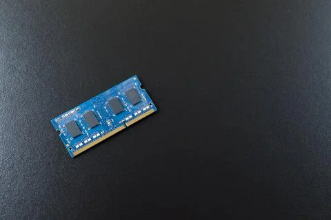 Computer memory chip placed on top of a black table. Connections and circuits Stock-Fotos
