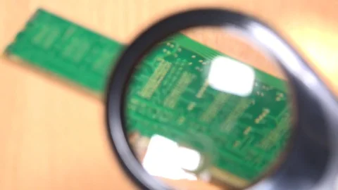 Computer memory module details with magnifying glass. pc diagnostics Stock Footage 73350434