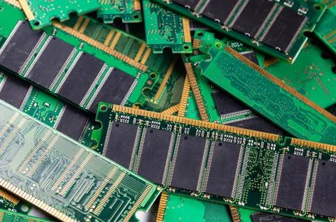 Computer memory modules stacked together on a green circuit board background Stock Photos