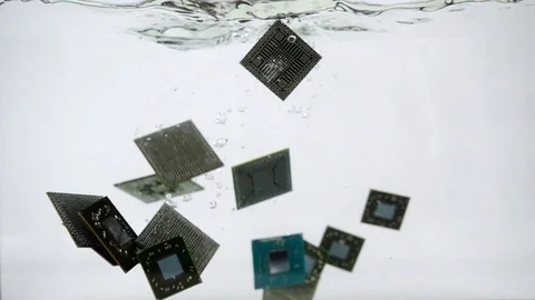 Computer micro processor fall into the water, slow motion Stock Footage 117924594