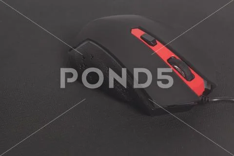 Computer modern gaming mouse on black mouse pad Stock Photos