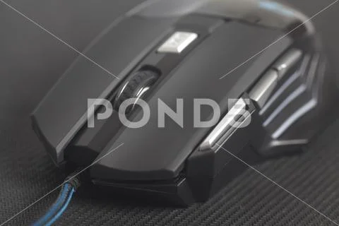 Computer modern gaming mouse on black mouse pad Stock Photos